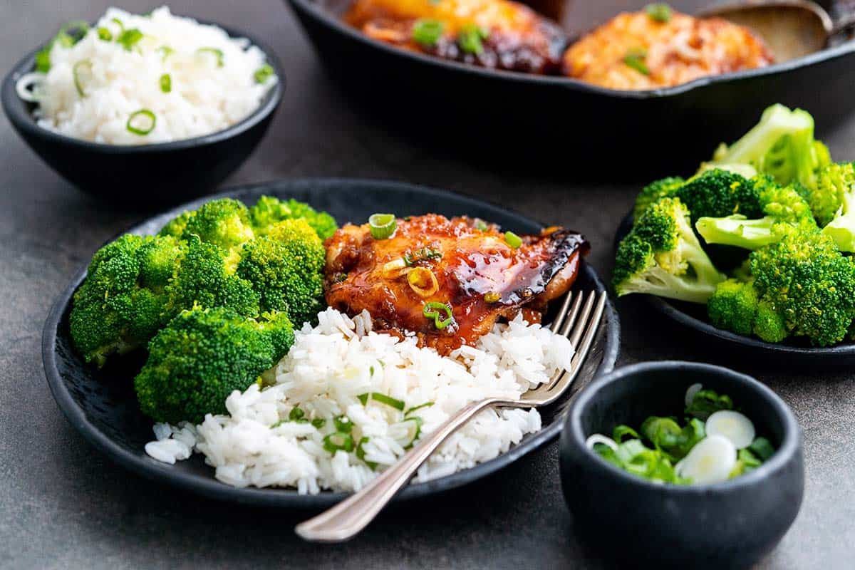 plate of roasted honey garlic chicken thighs with rice and broccoli