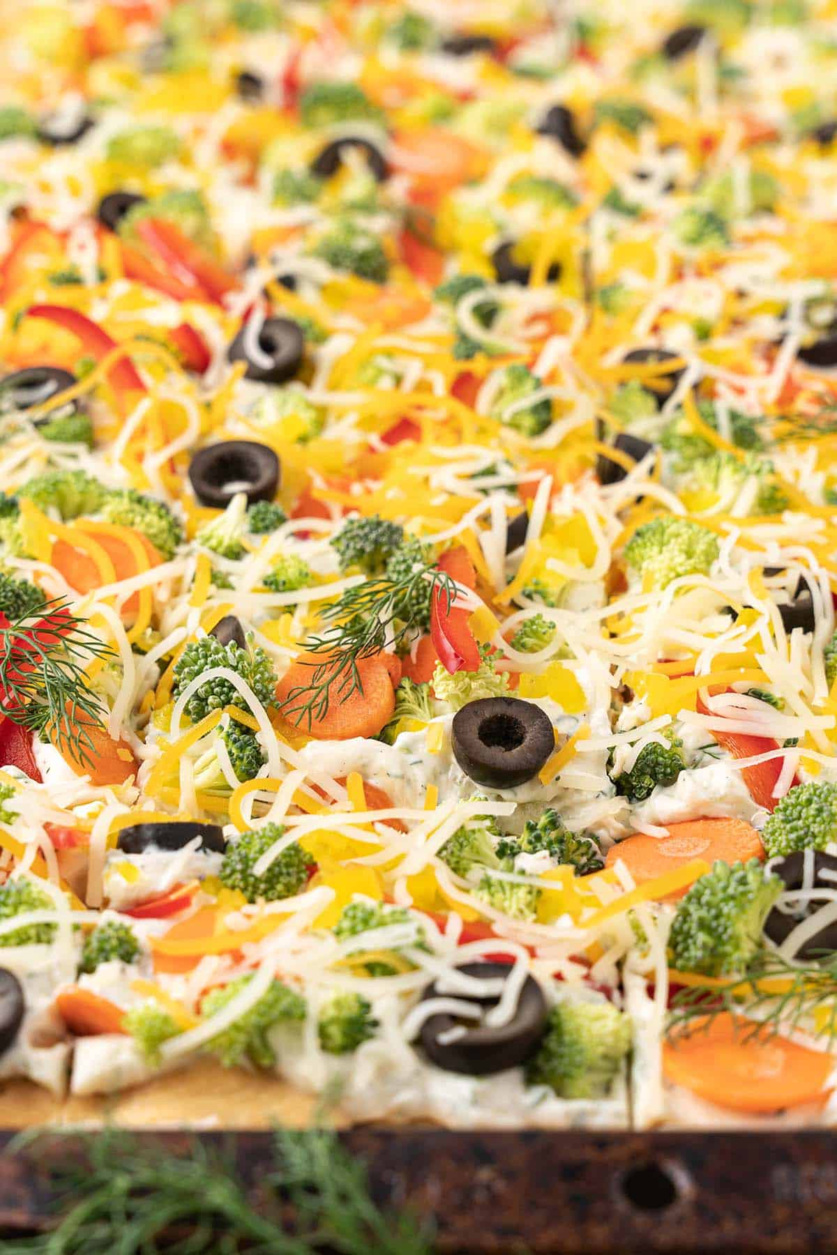close up of cold veggie pizza appetizer with ranch