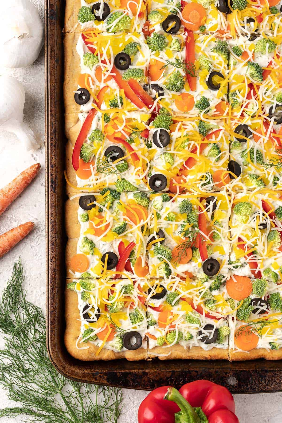 overhead view of tray of crescent roll vegetable pizza
