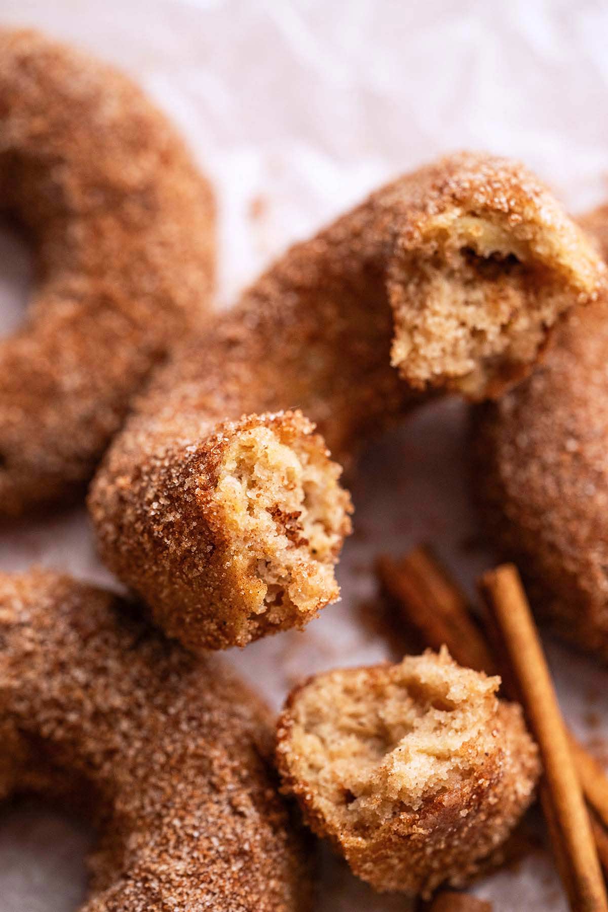 pile of homemade apple donuts with cinnamon