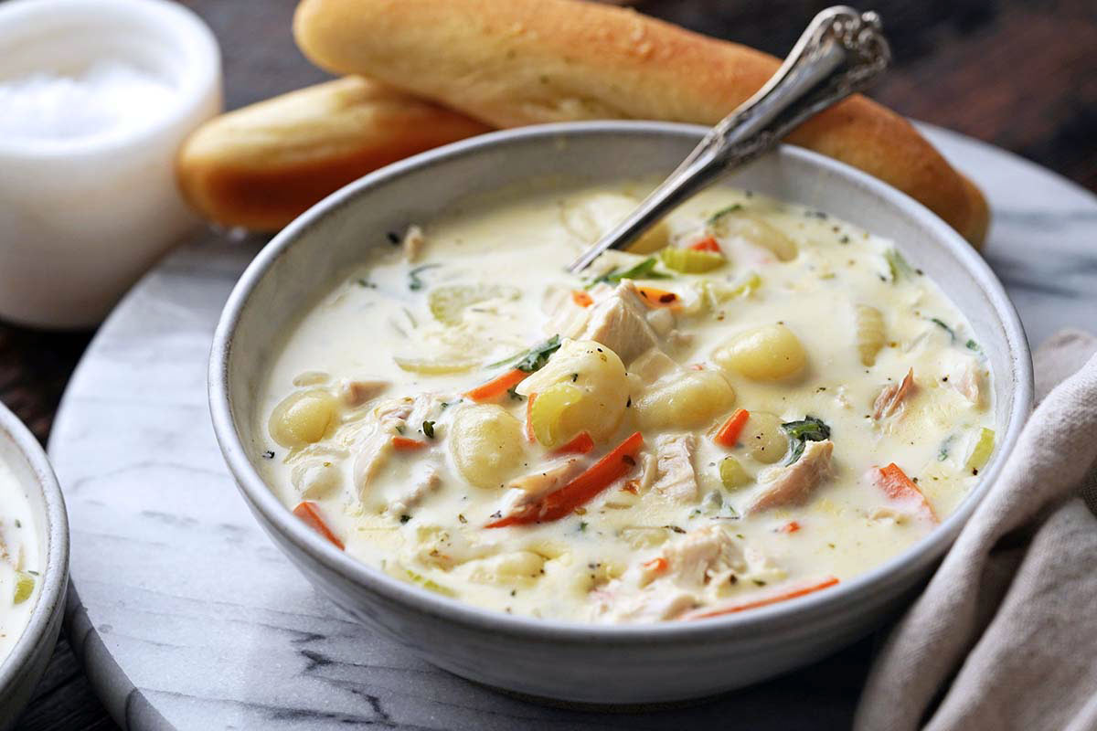 bowl with creamy chicken soup with potato gnocchi