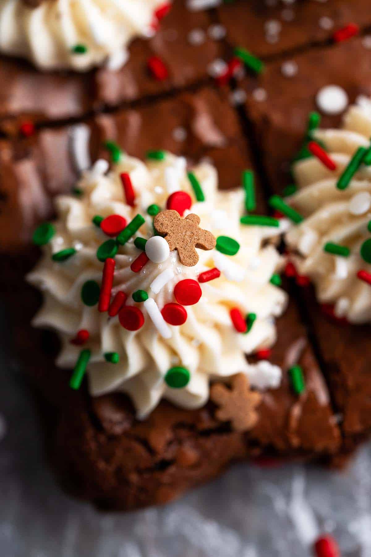 close up of eggnog buttercream and christmas sprinkles on brownies