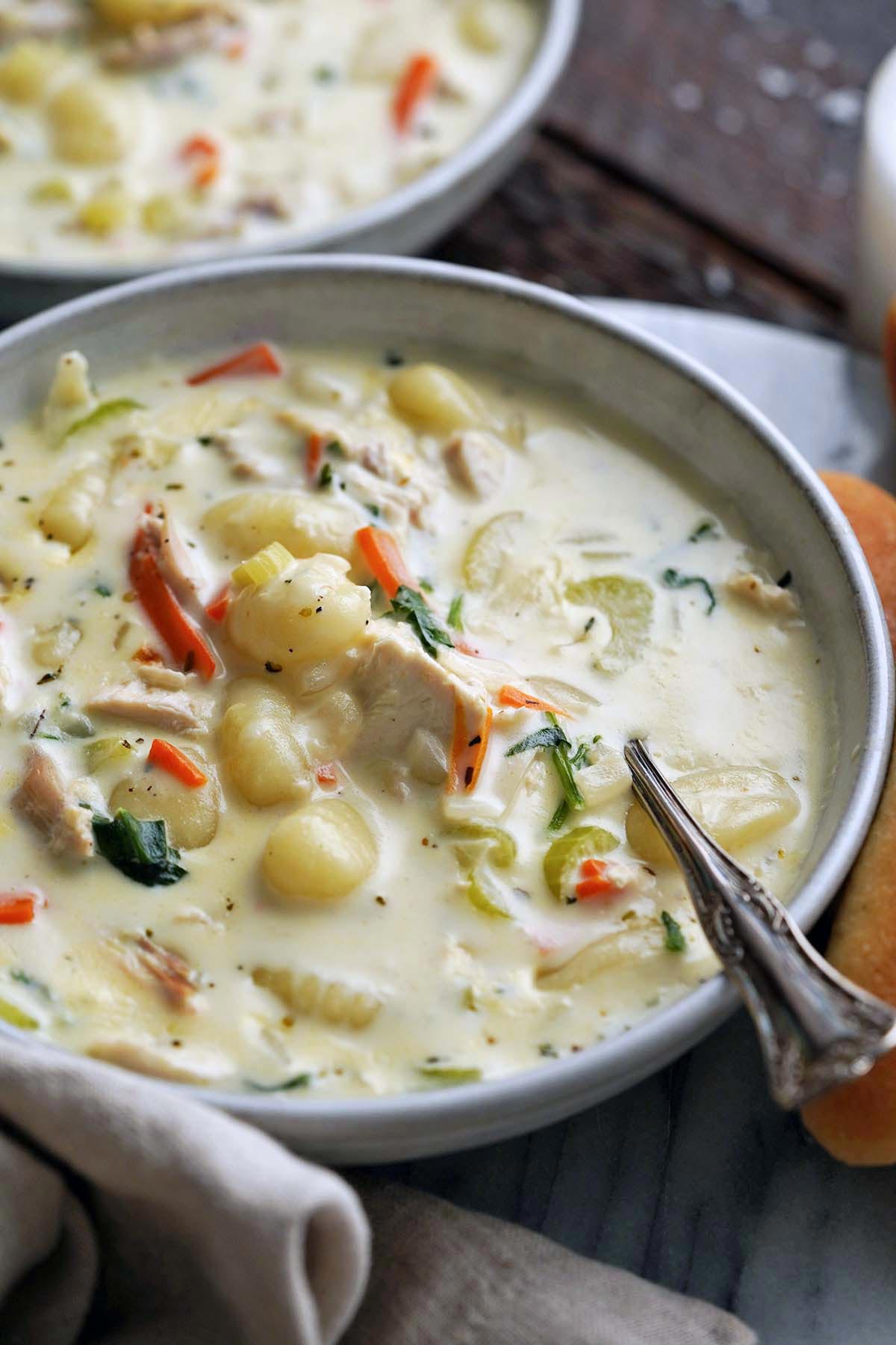 front view of stoneware bowl with easy chicken gnocchi soup