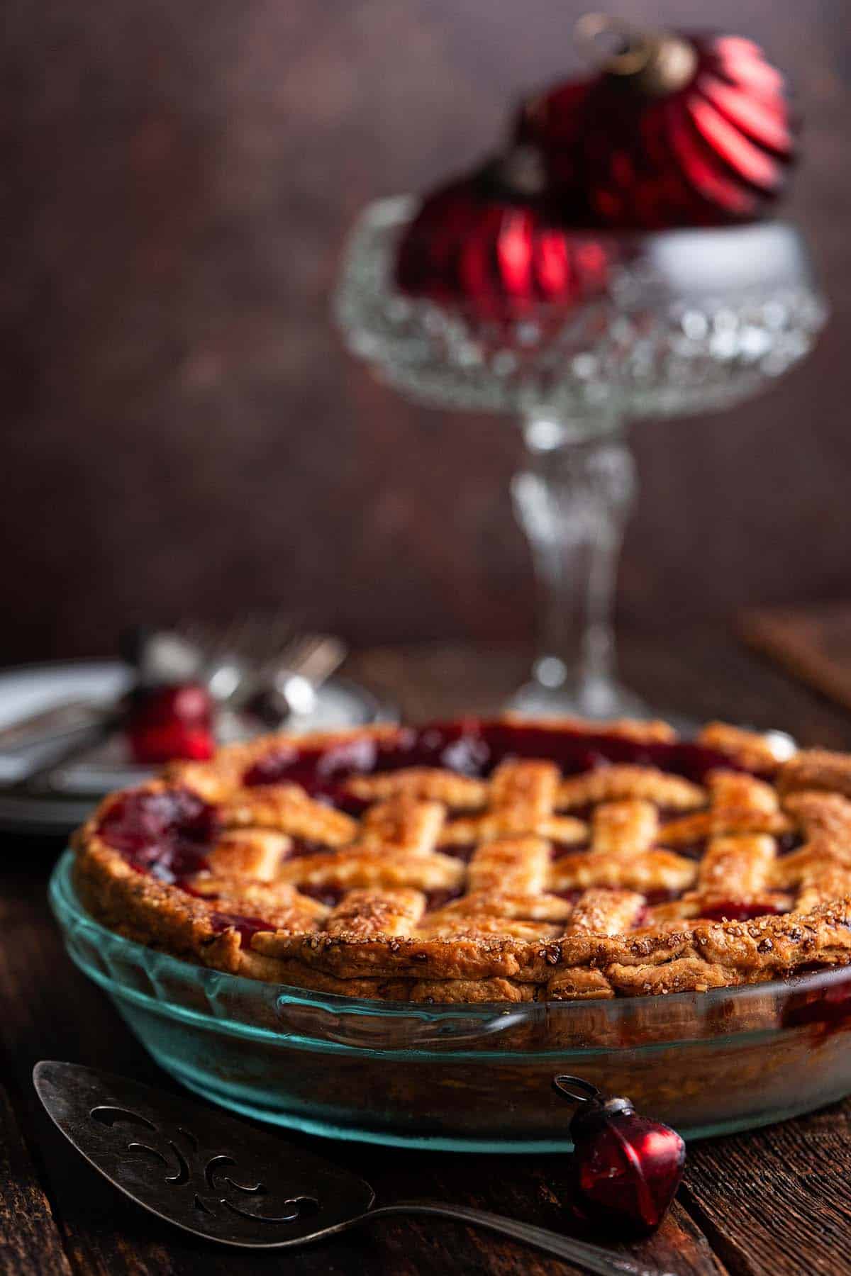 lattice topped cranberry pie with christmas ornaments