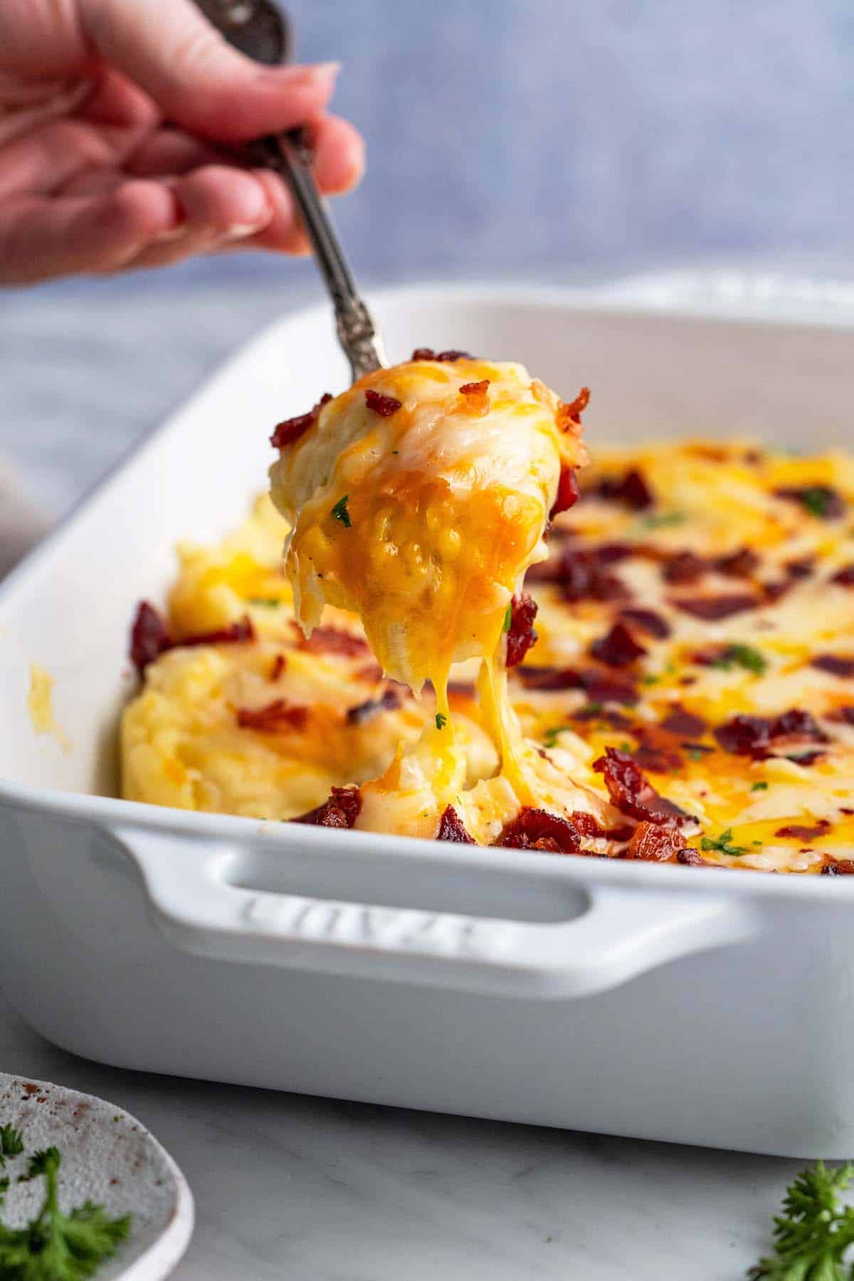 serving twice baked mashed potato casserole with cheese
