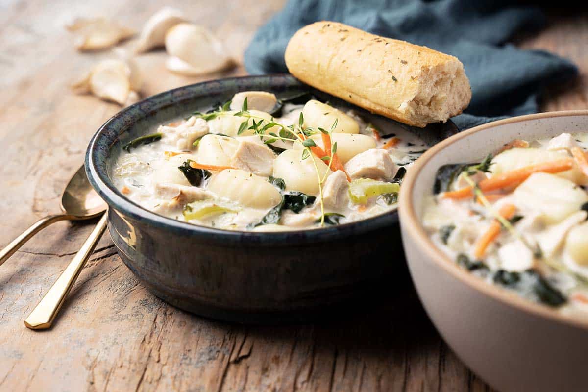 two bowls of creamy chicken gnocchi soup