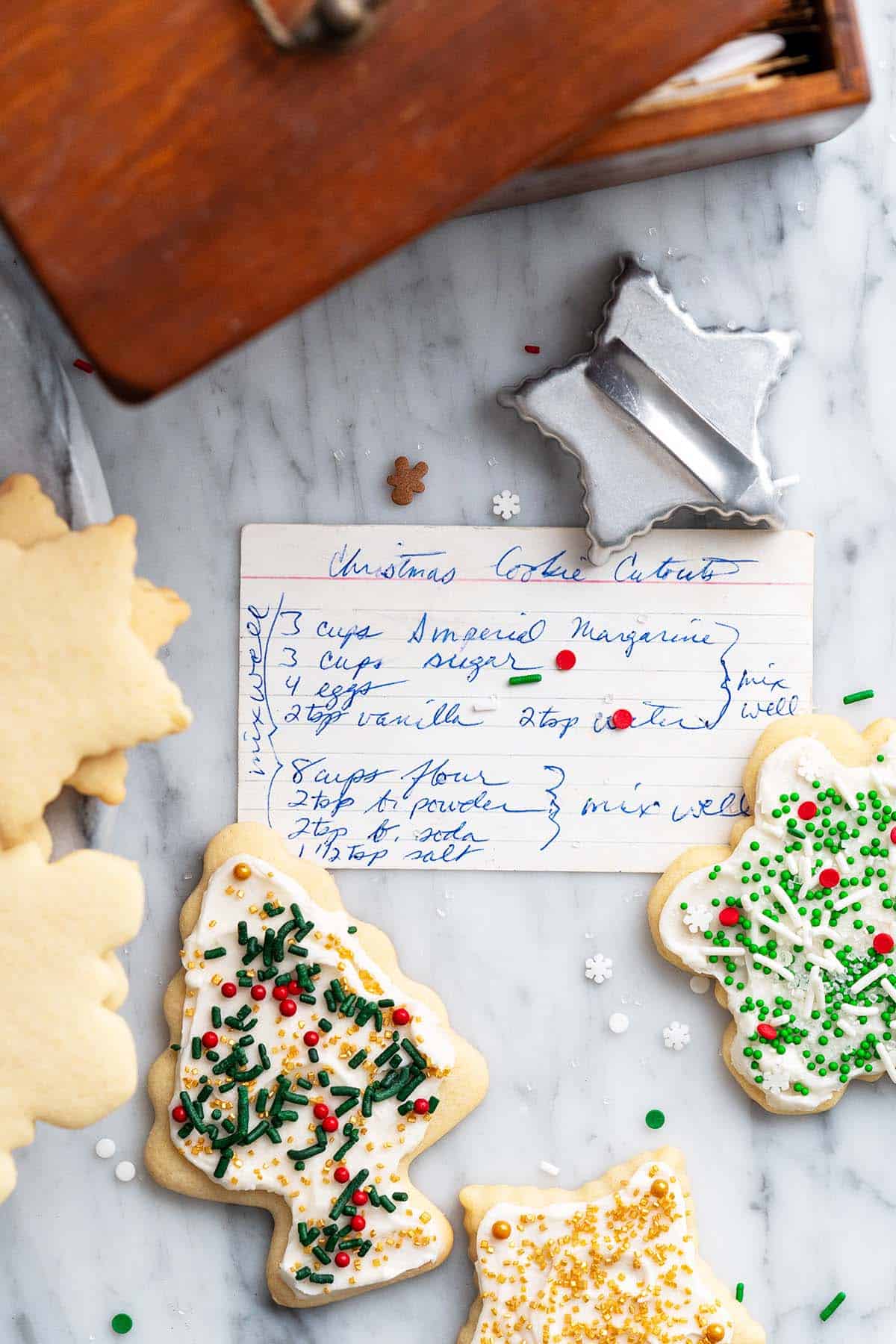 handwritten christmas cutout cookies recipe with vintage recipe box and cookies