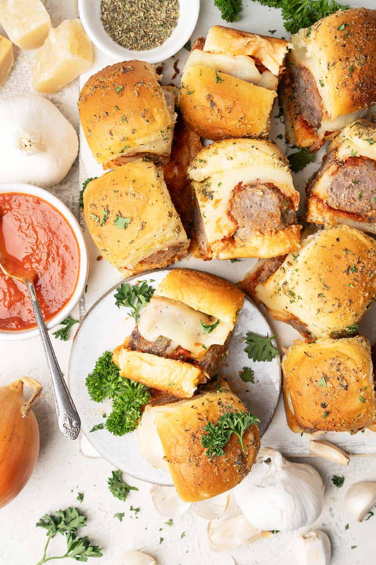 overhead view of cooked meatball sliders with marinara sauce