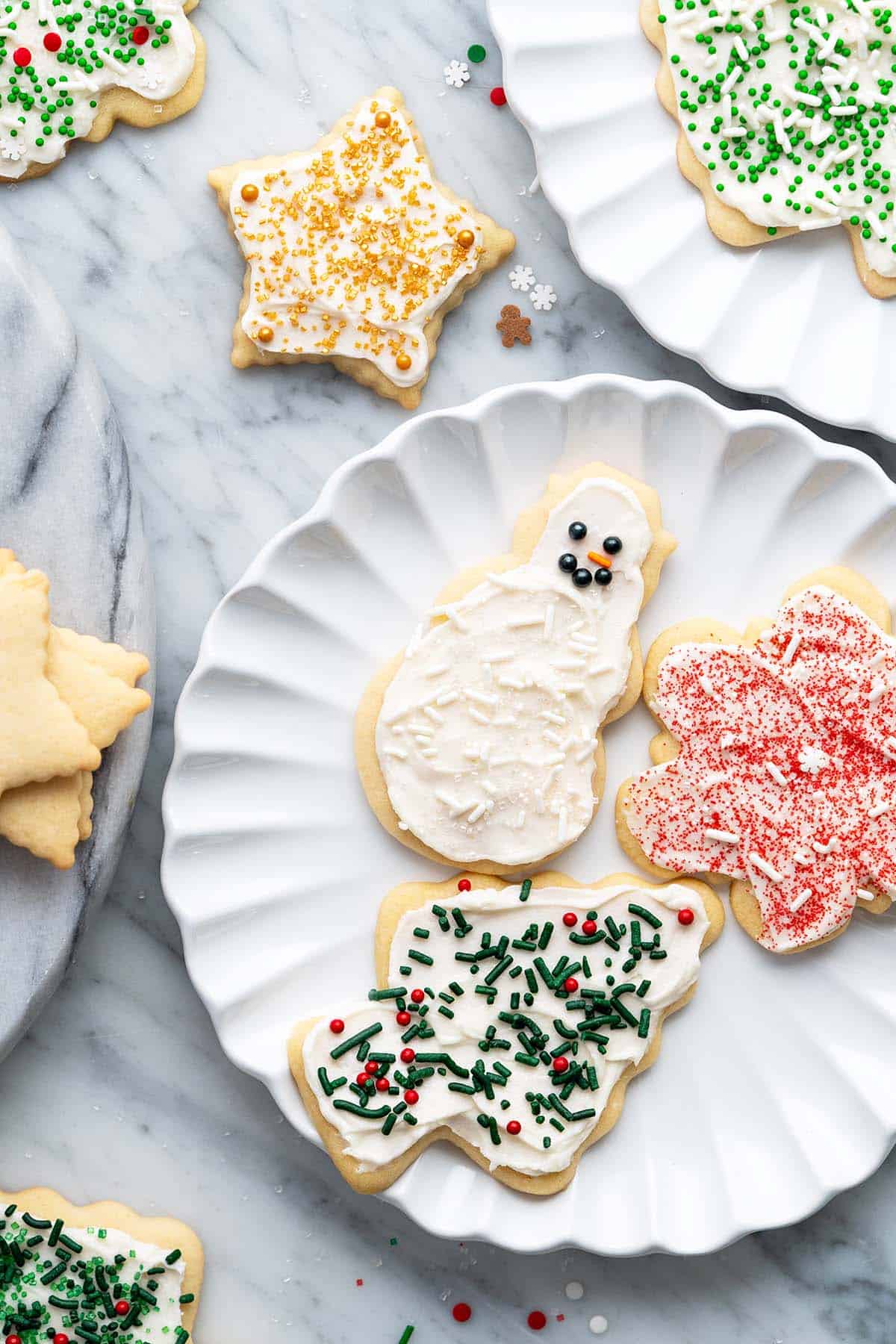 overhead view of plate of decorated christmas sugar cookies