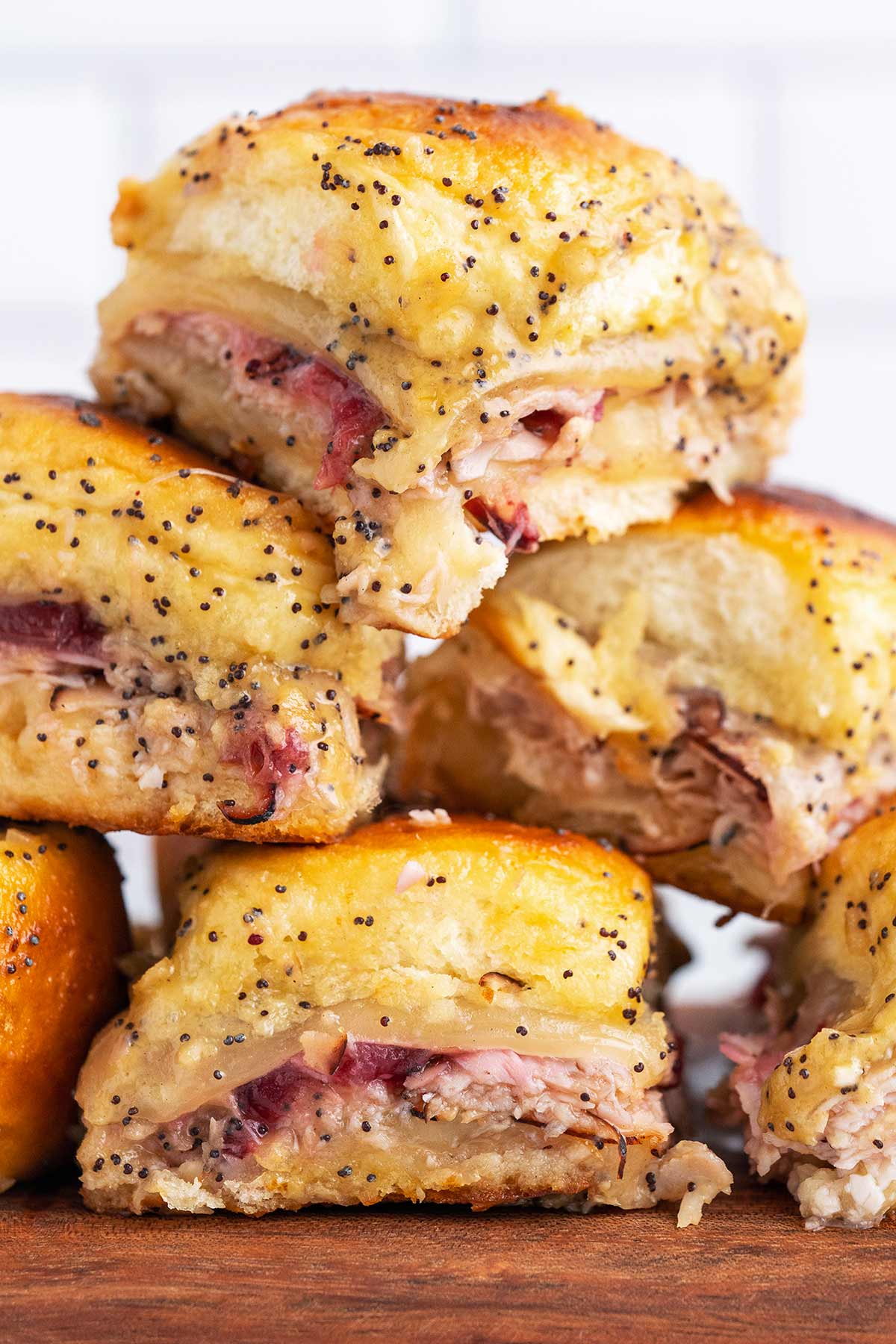 stack of sliders on wooden serving platter