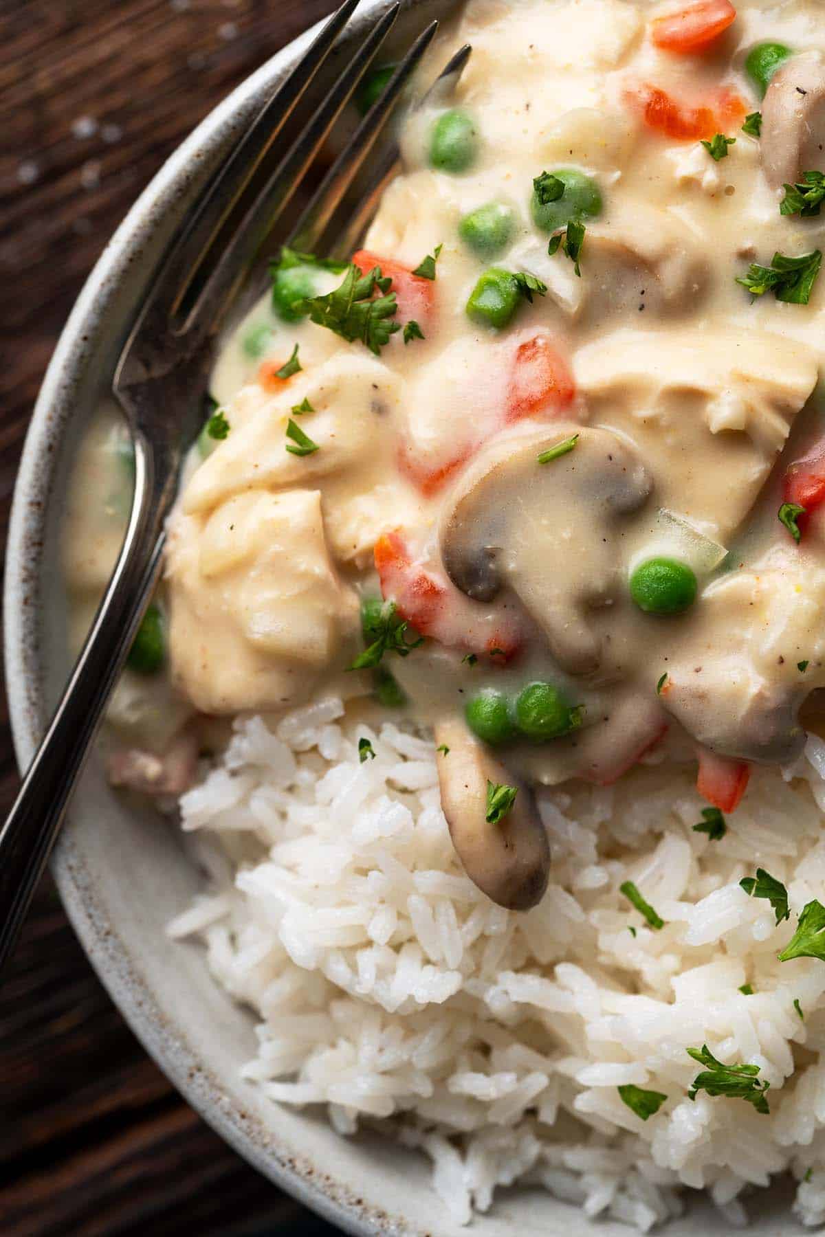 close up overhead view of creamy chicken a la king served on rice