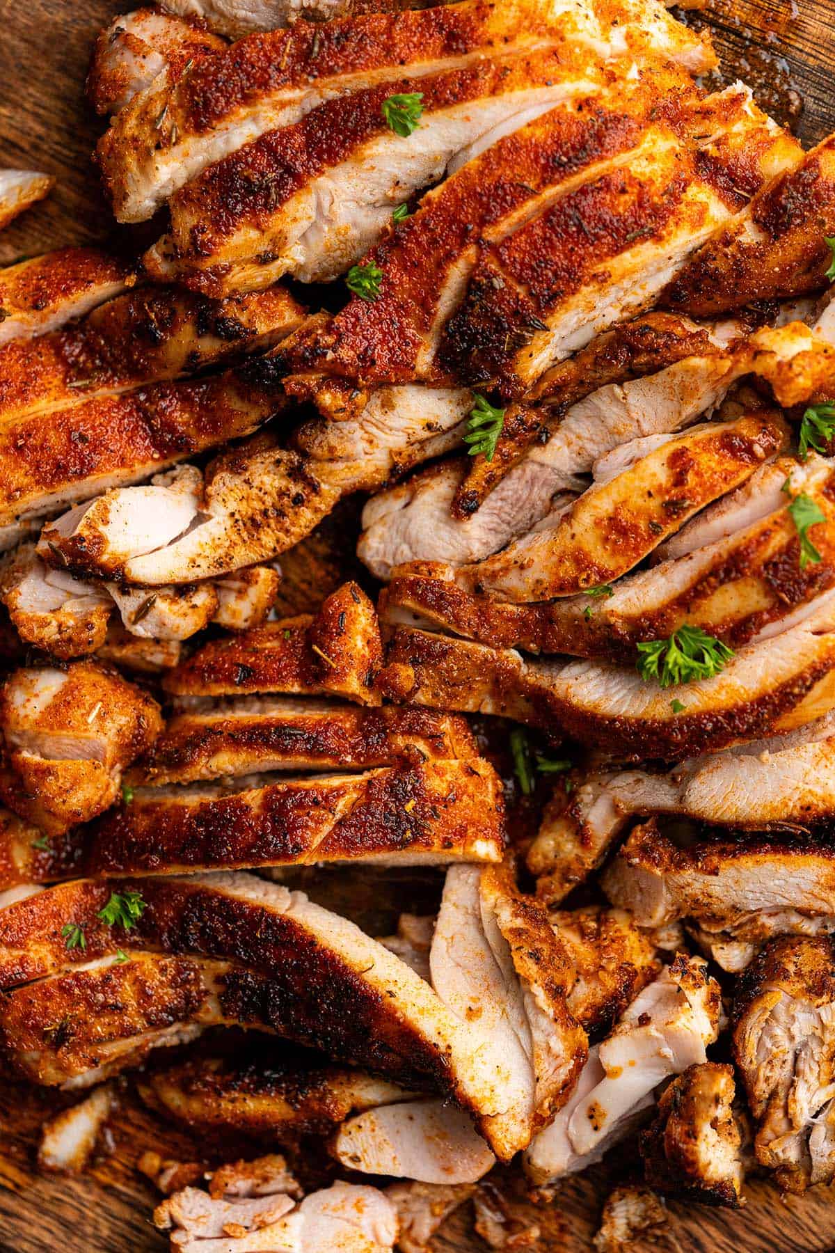 close up top view of sliced blackened chicken on cutting board