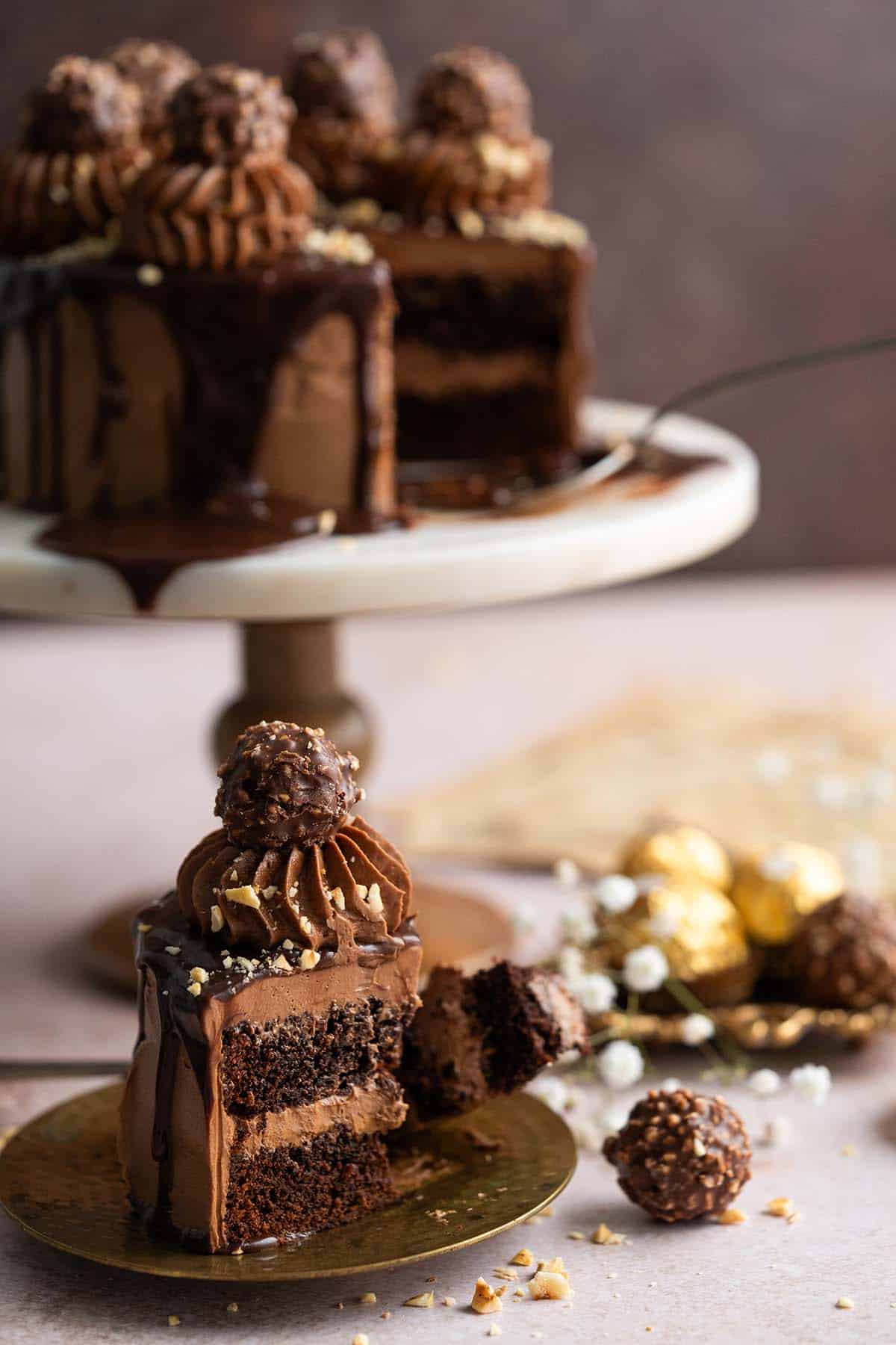 partially eaten slice of nutella cake with cake on stand in background