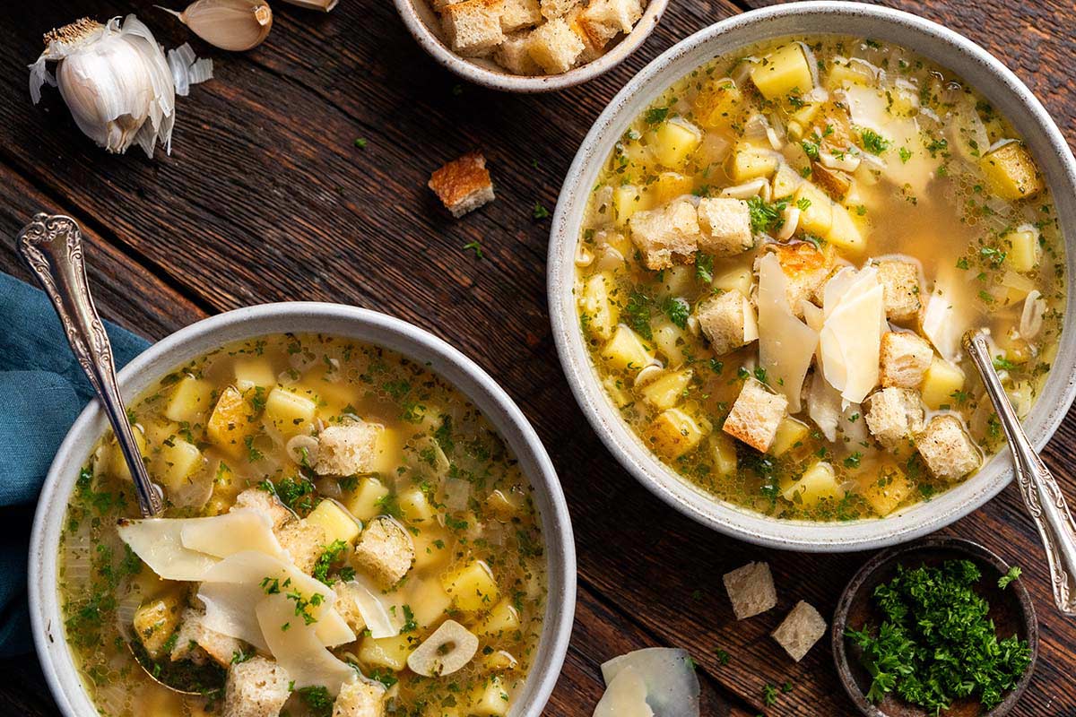 stoneware bowls of cesnecka soup topped with croutons and cheese