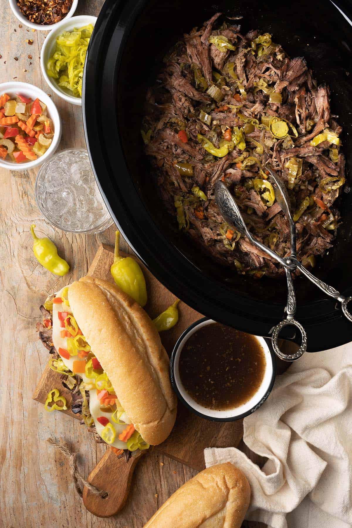 spread of slow cooker italian beef with peppers and au jus