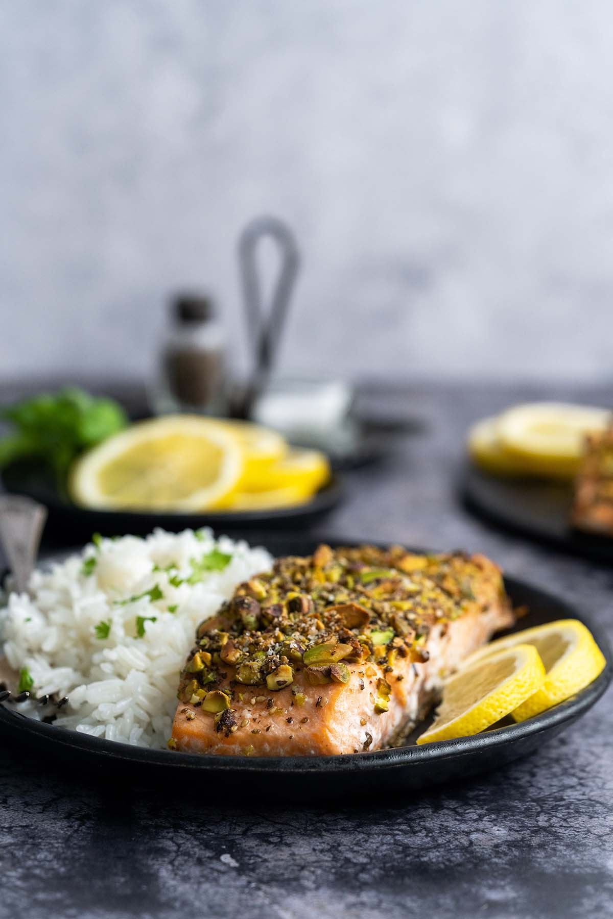 front view of plated pistachio salmon with side of rice