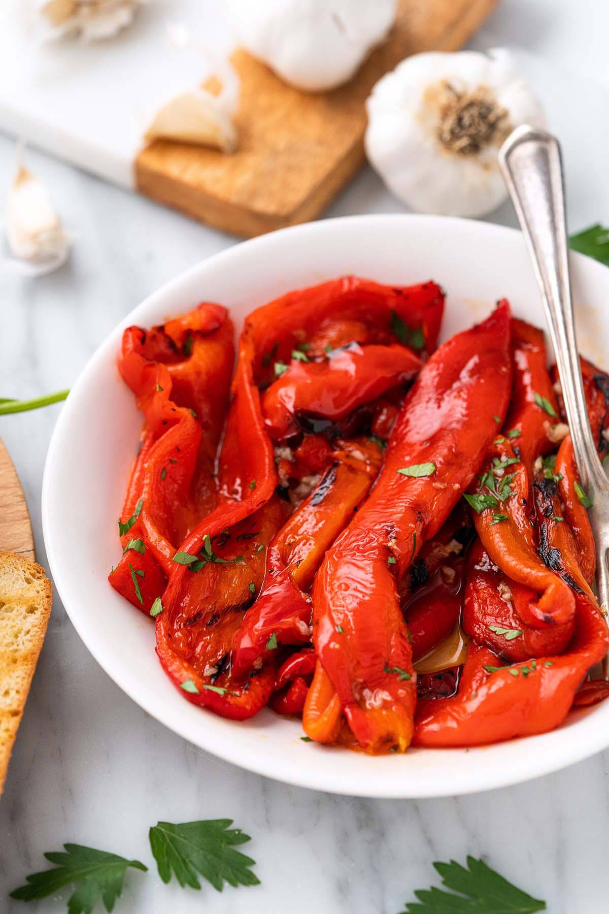 close up of fire roasted red peppers in bowl