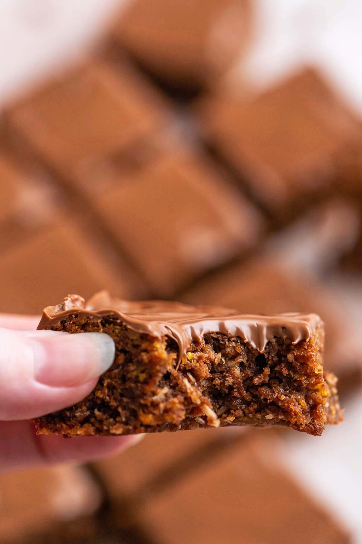 hand holding piece of australian crunch with bite