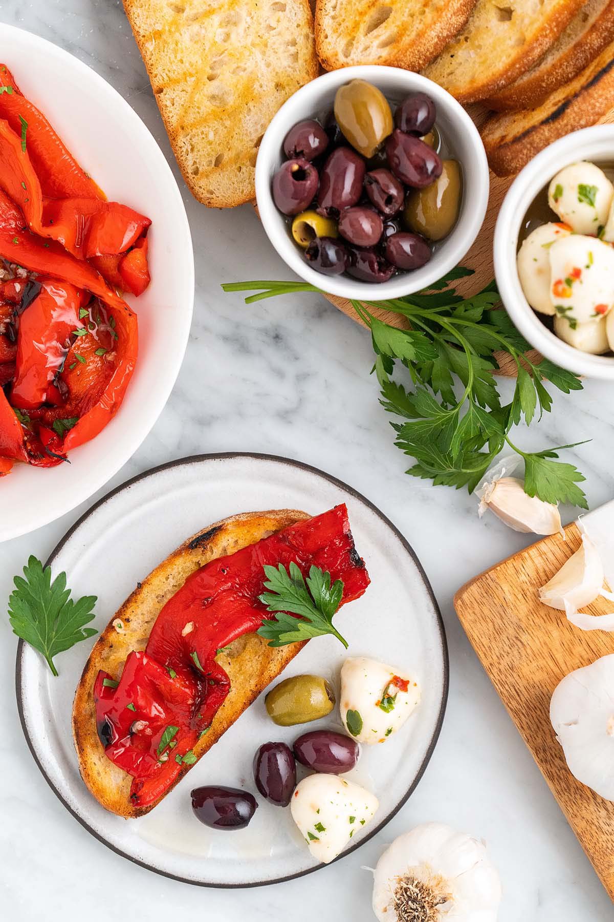 roasted red peppers Italian appetizer spread with bread and olives