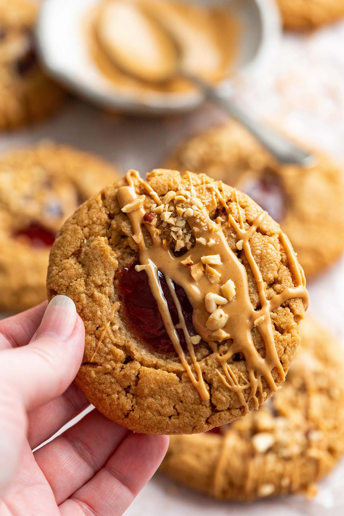 hand holding peanut butter jelly cookie