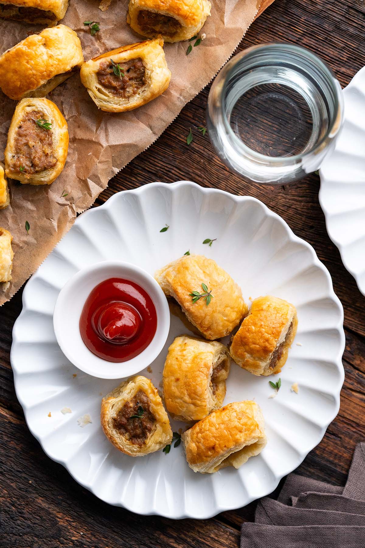 plate of homemade sausage rolls made with puff pastry with side of ketchup
