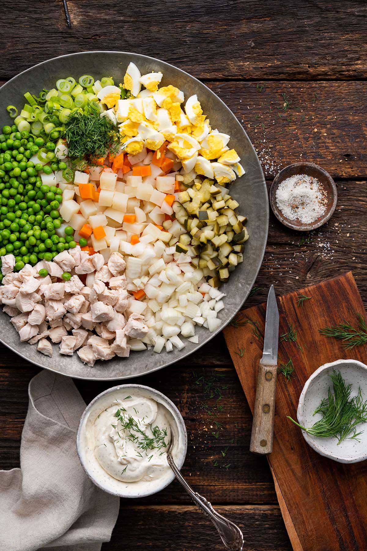 ingredients in Russian salad with potato and mayo