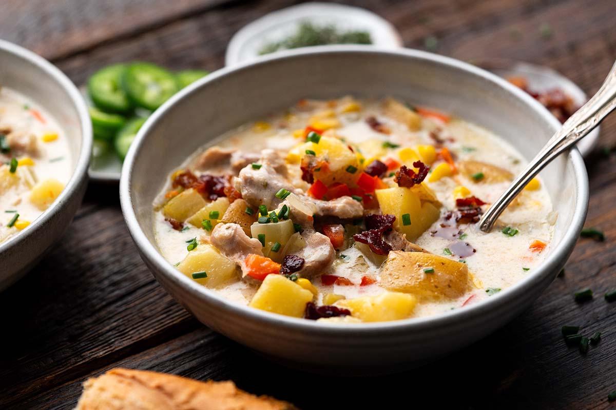 white ceramic bowl with creamy chicken corn potato soup