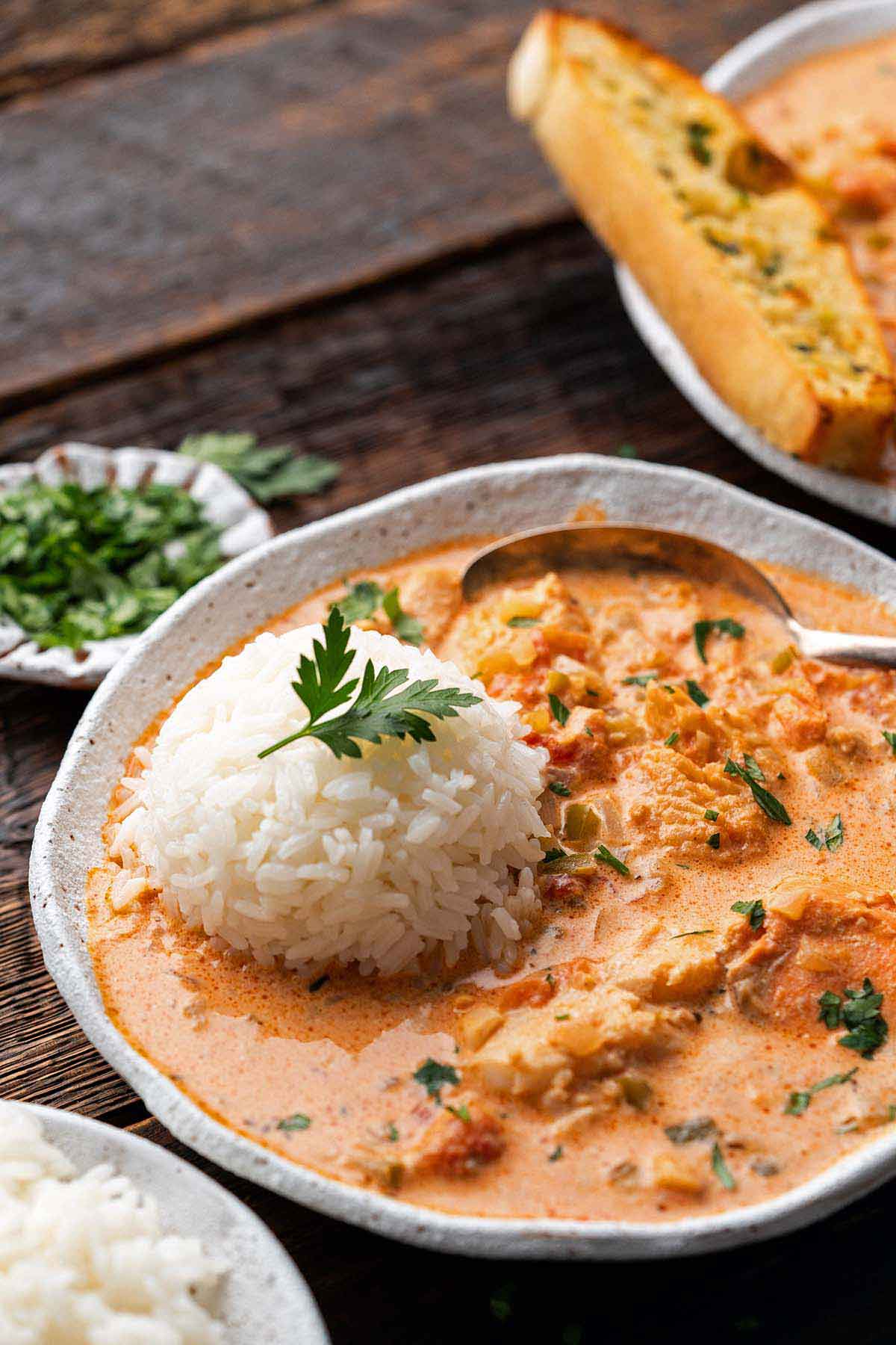 close up front view of stoneware bowl with Las Vegas style seafood pan roast with rice