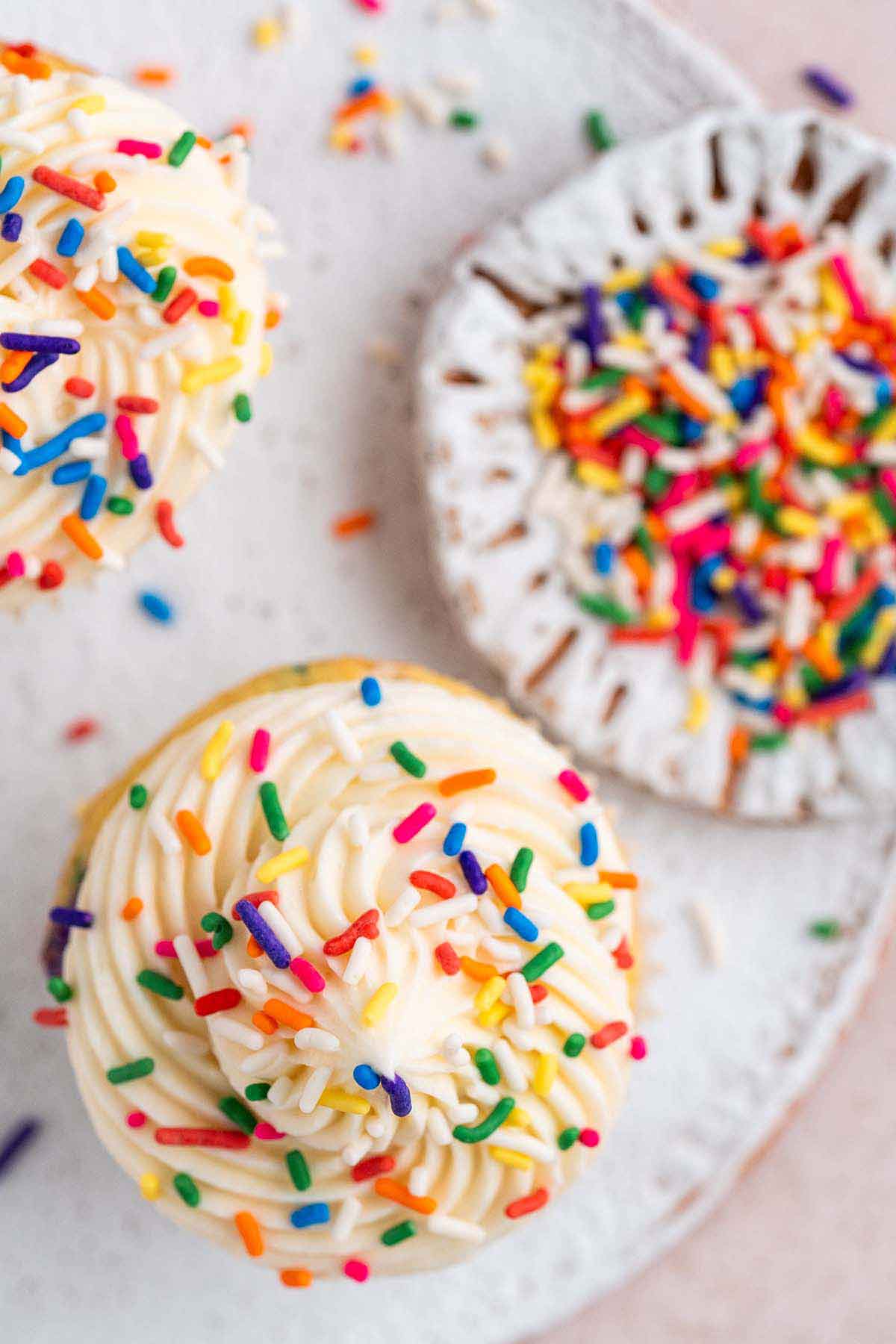 close up top view of birthday cake cupcakes with vanilla buttercream and rainbow jimmies