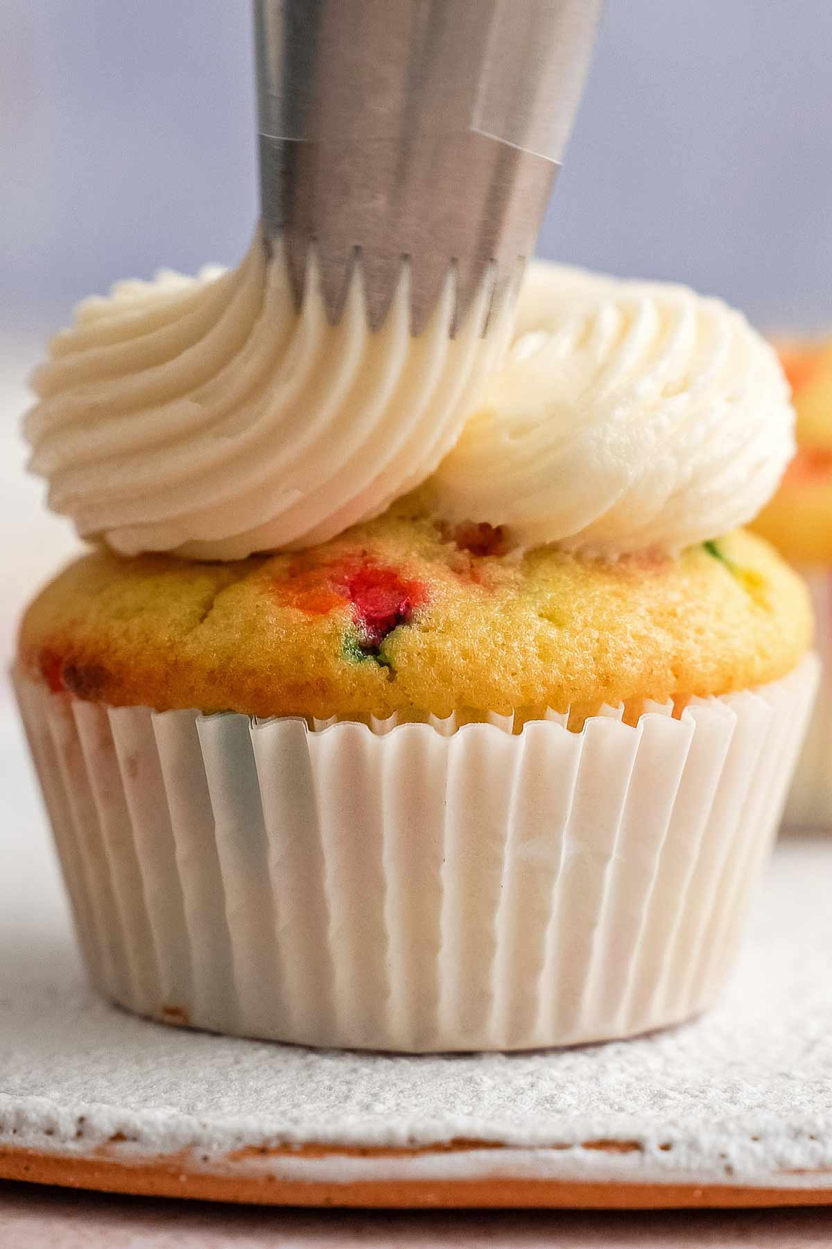piping buttercream on cupcake