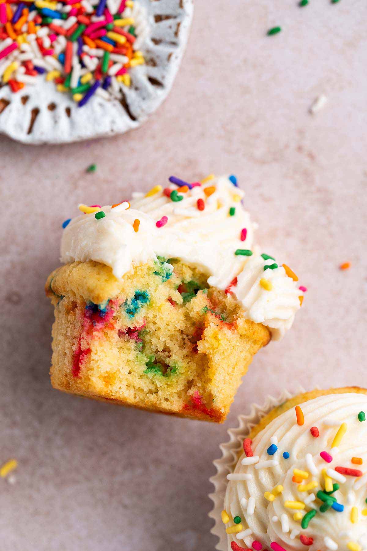 top view of funfetti cupcake with bite to show moist cake