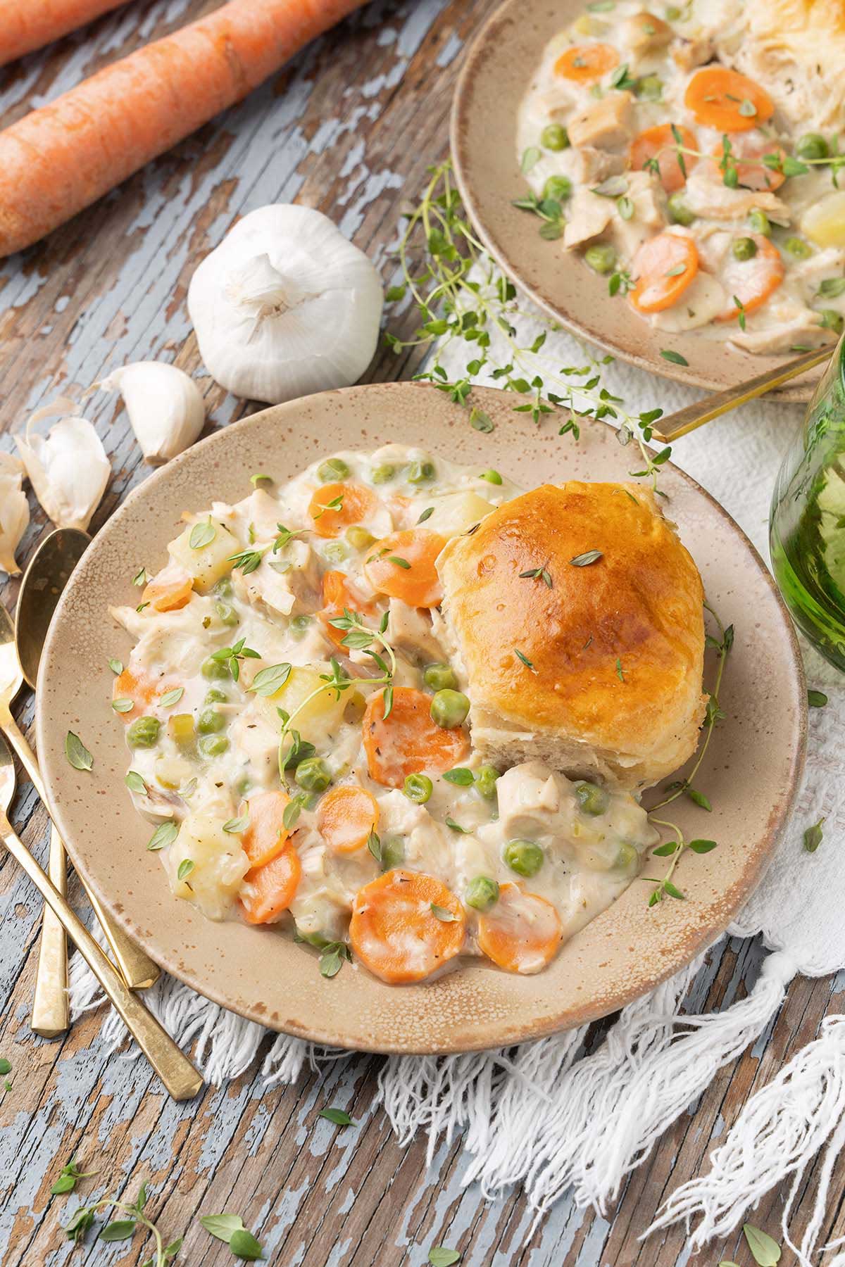 front view of bowl of cozy chicken pot pie recipe with biscuit topping