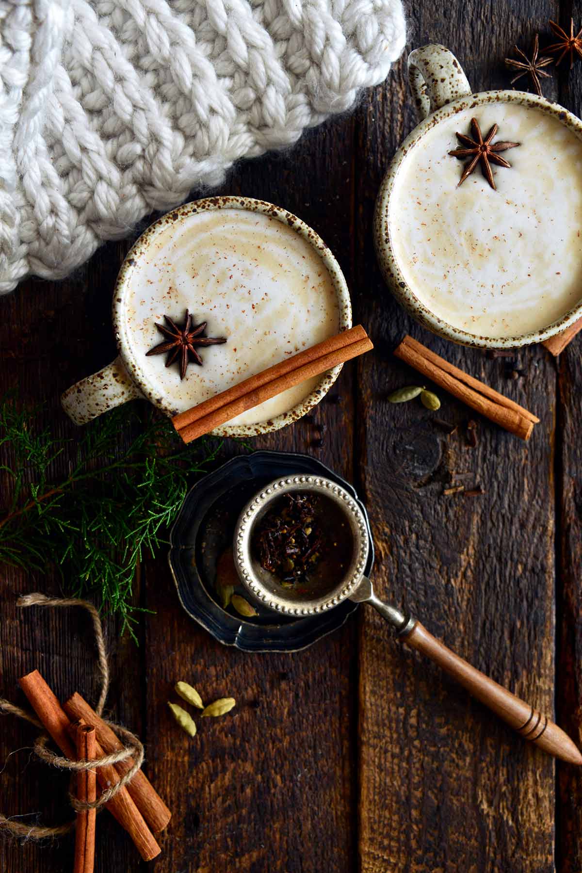 cozy dirty chai lattes in stoneware mugs on rustic wooden table