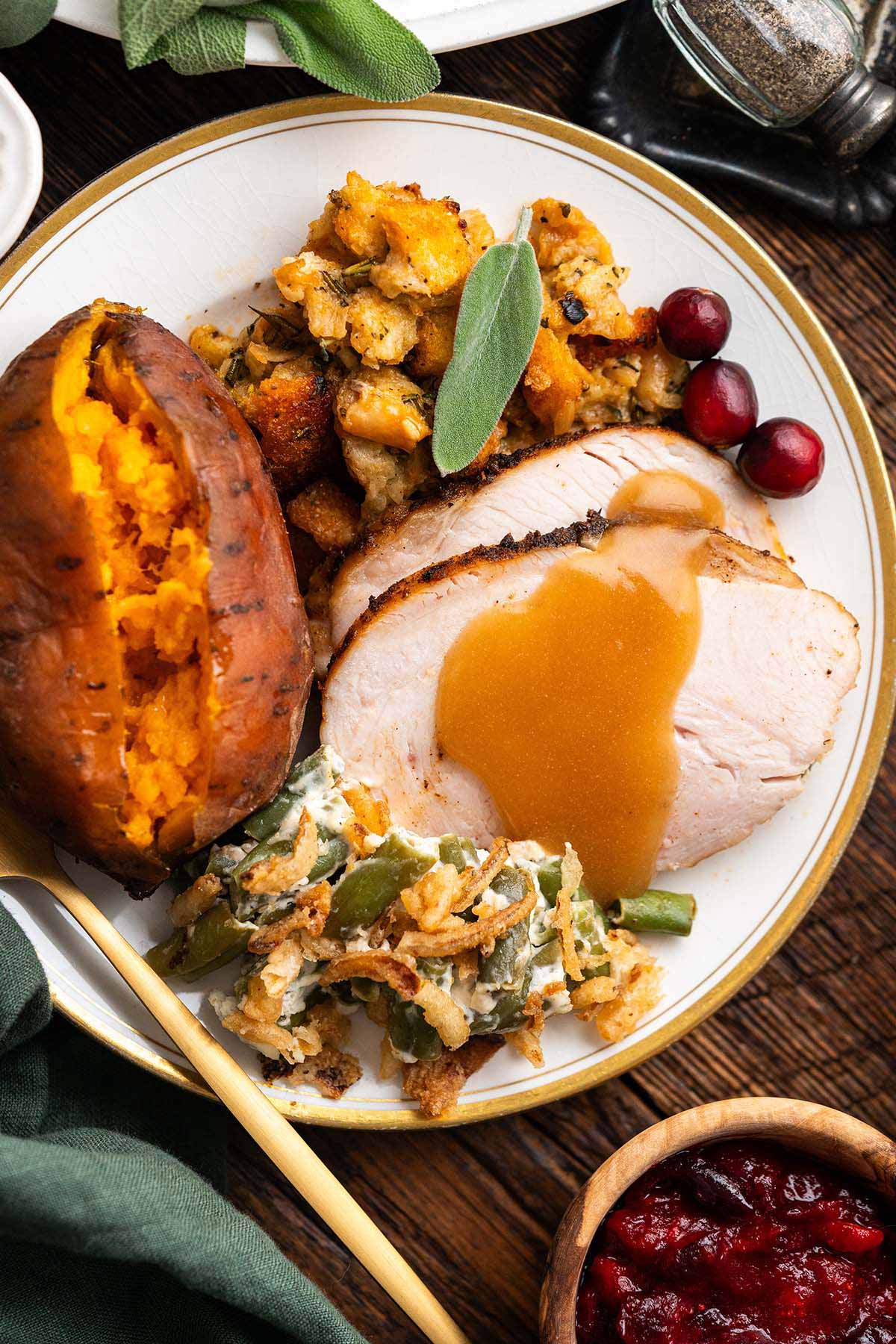 close up top view of plate of thanksgiving turkey dinner with holiday side dishes