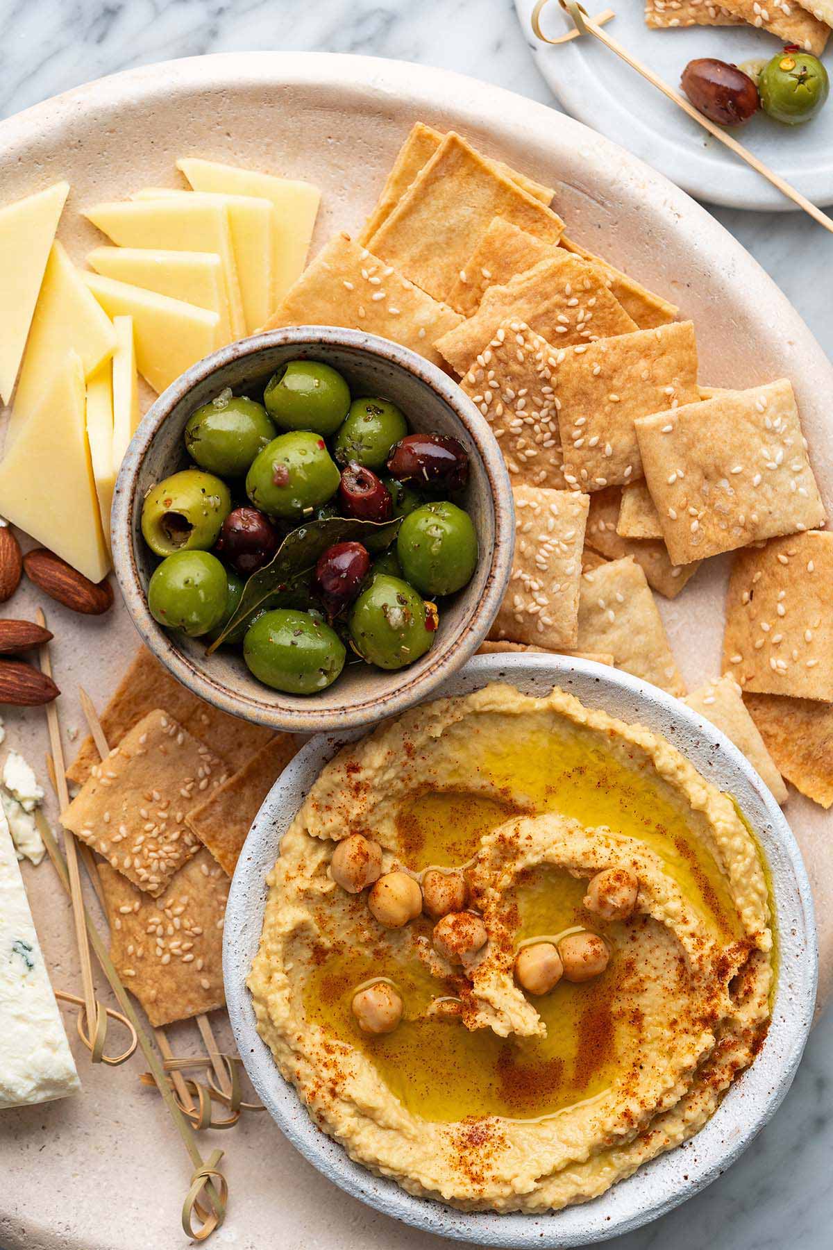 cheese board with tahini free hummus and crackers