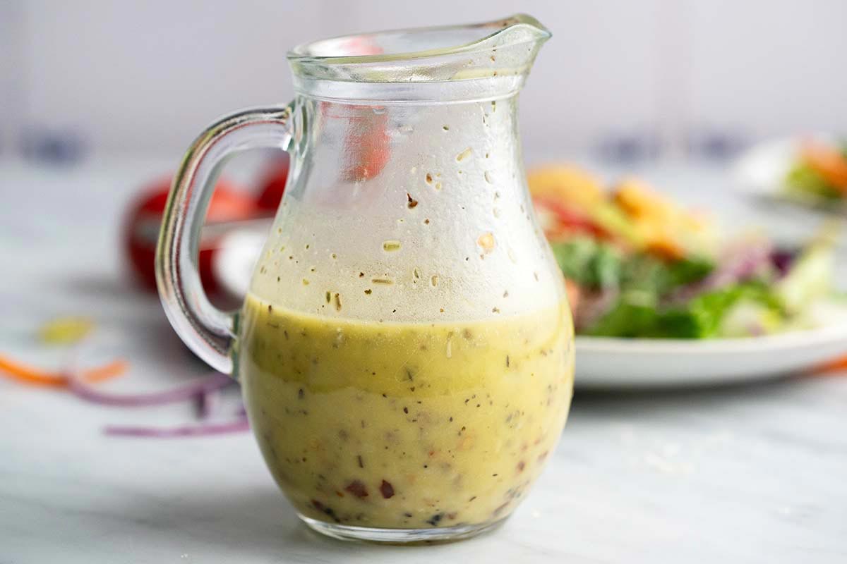 small glass jug of homemade vinaigrette