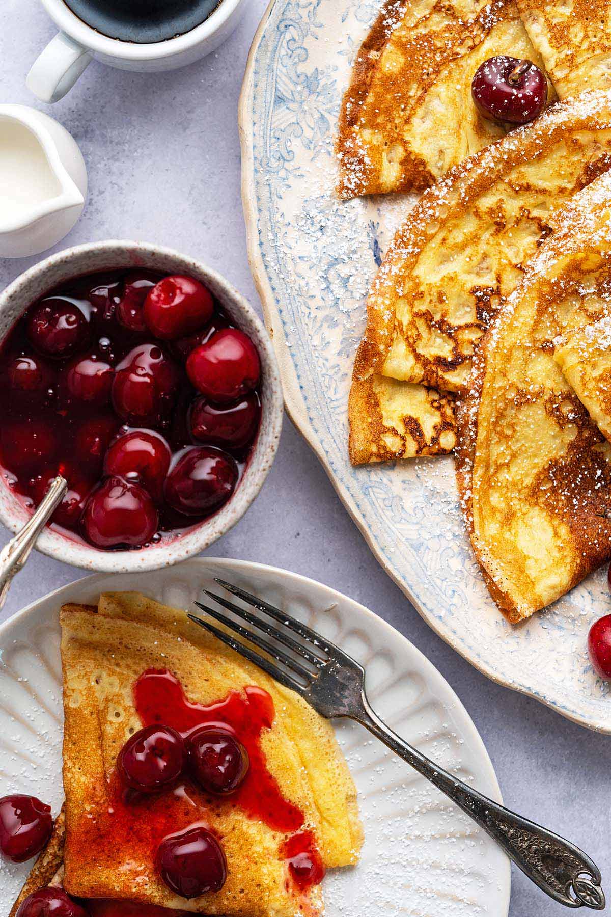 breakfast spread with cherry topping and crepes
