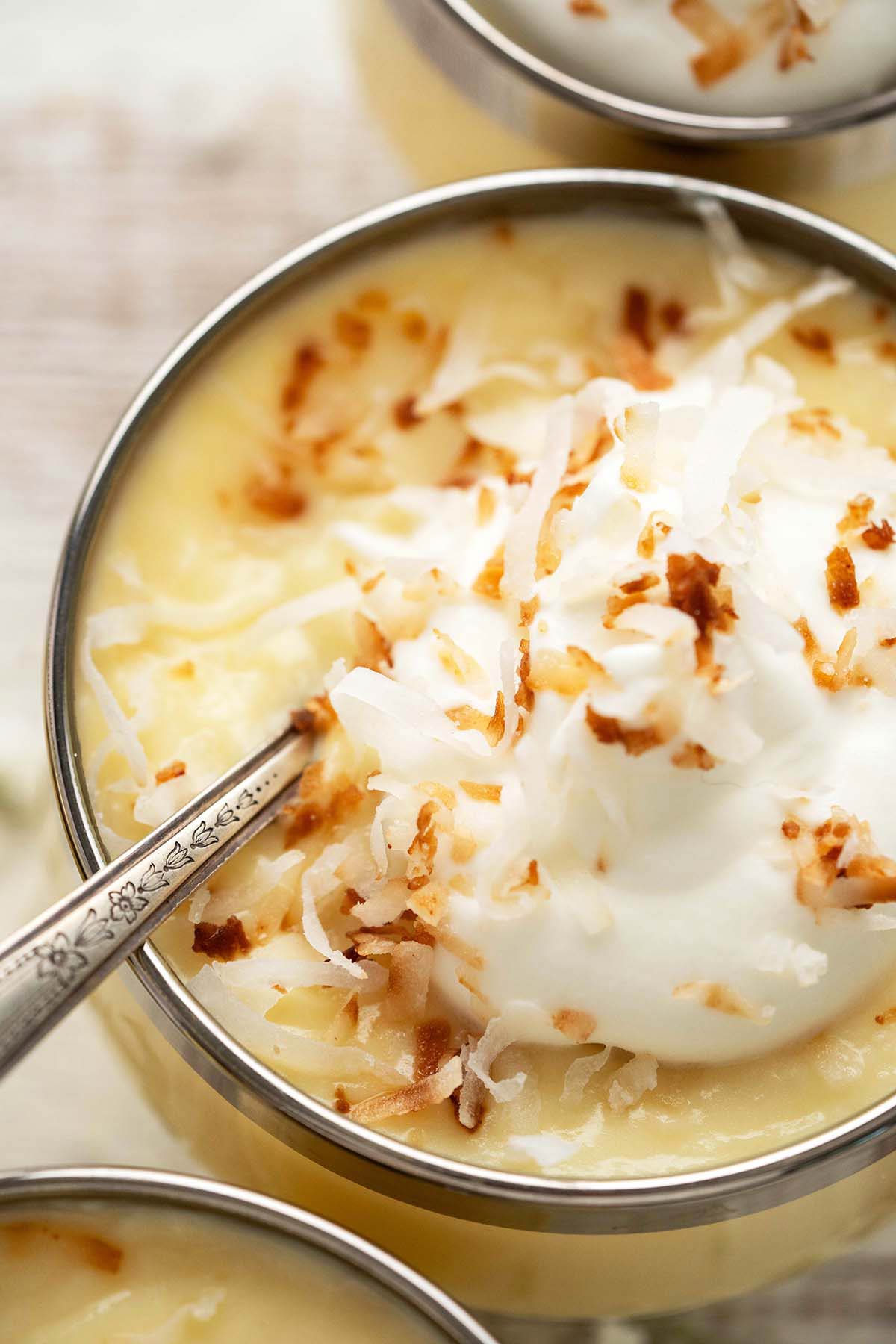 close up of toasted coconut and whipped cream on pudding