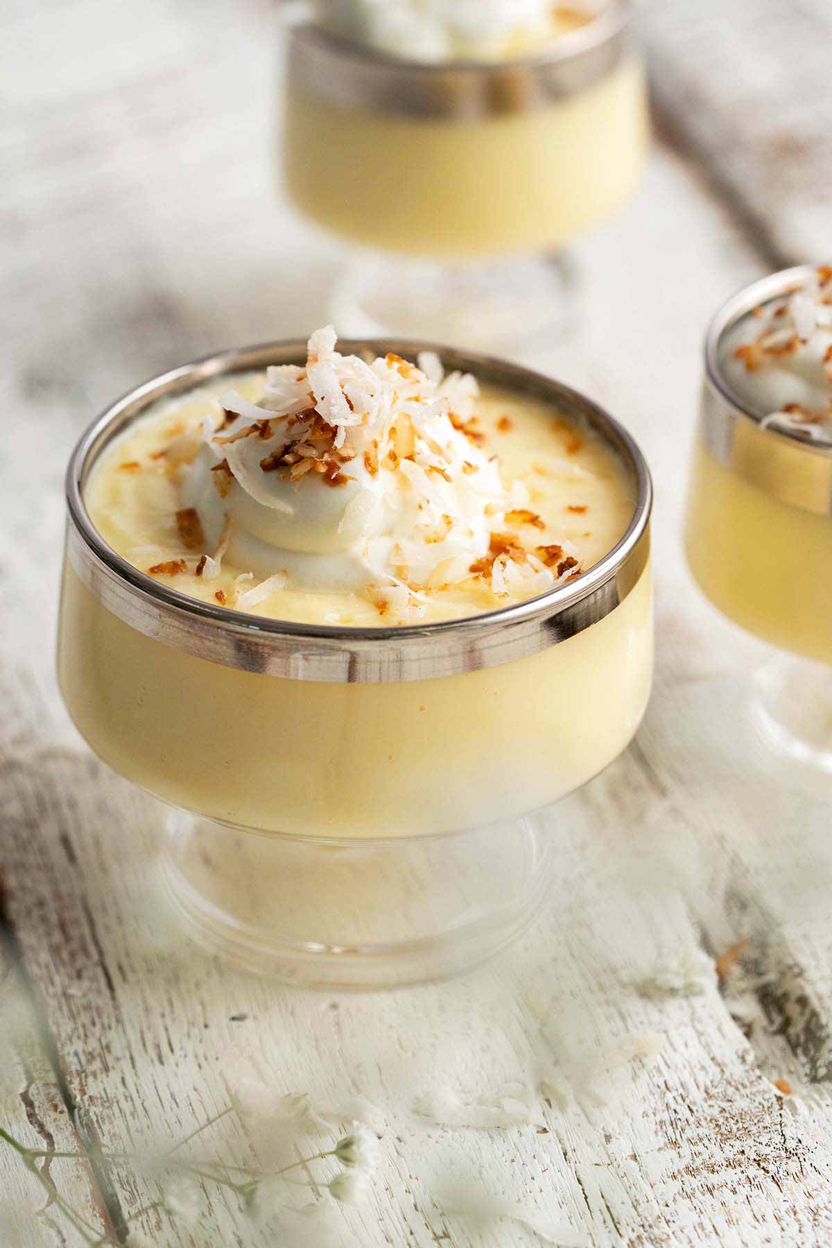 front view of homemade coconut pudding on white wooden table