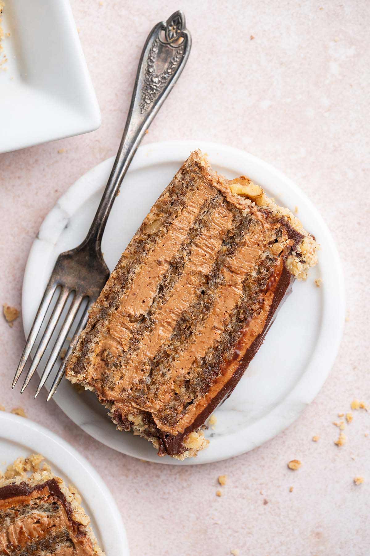 top view of slice of Serbian reform cake showing beautiful chocolate cream layers with walnut sponge