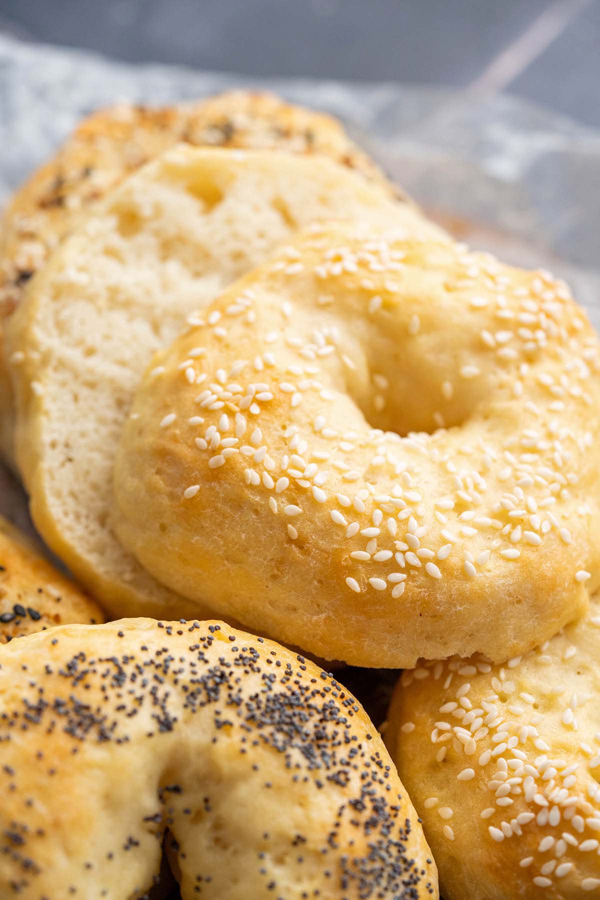 close up of chewy protein bagels topped with sesame seeds poppy seeds and everything seasoning