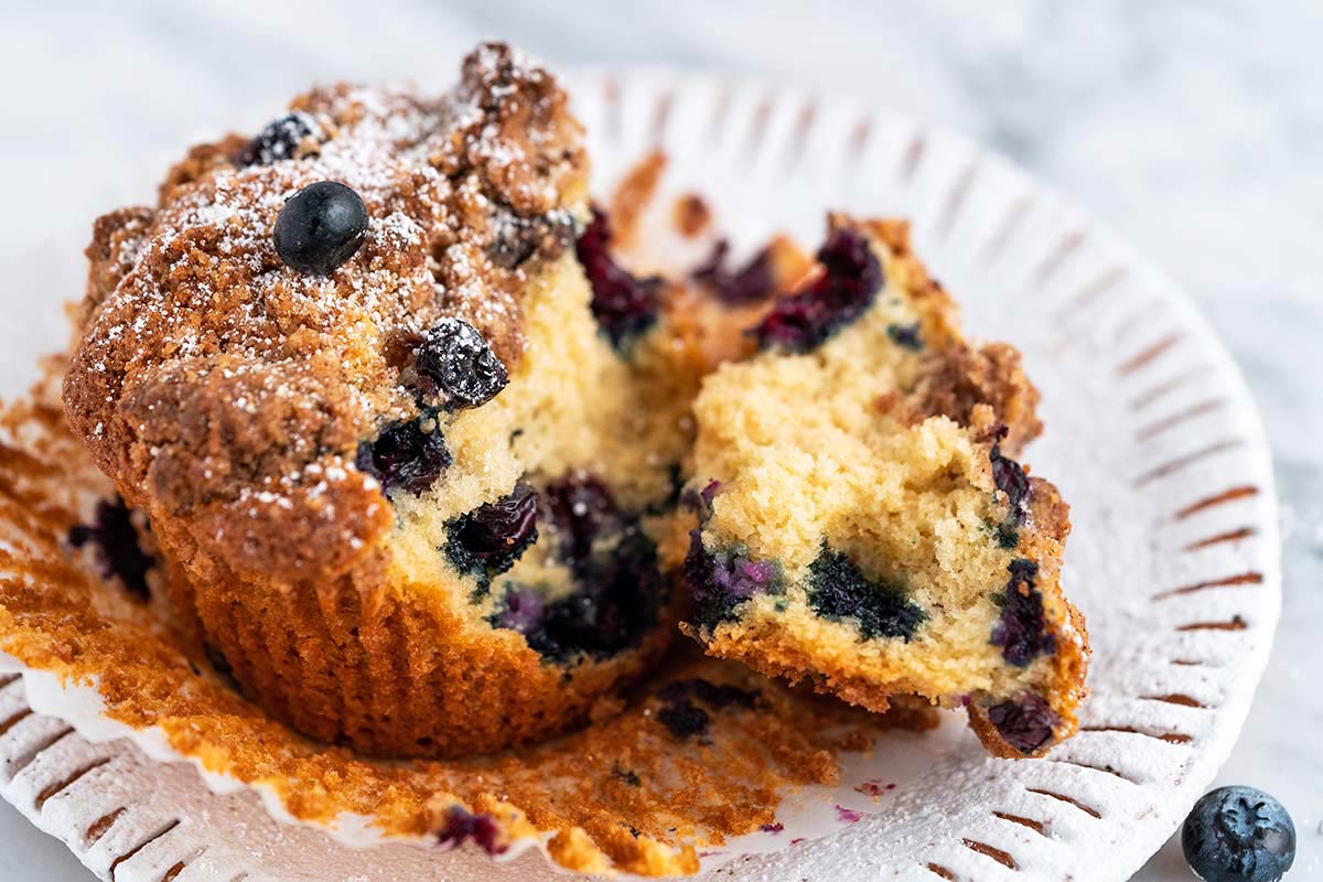 close up of moist small batch blueberry muffins on stoneware plate