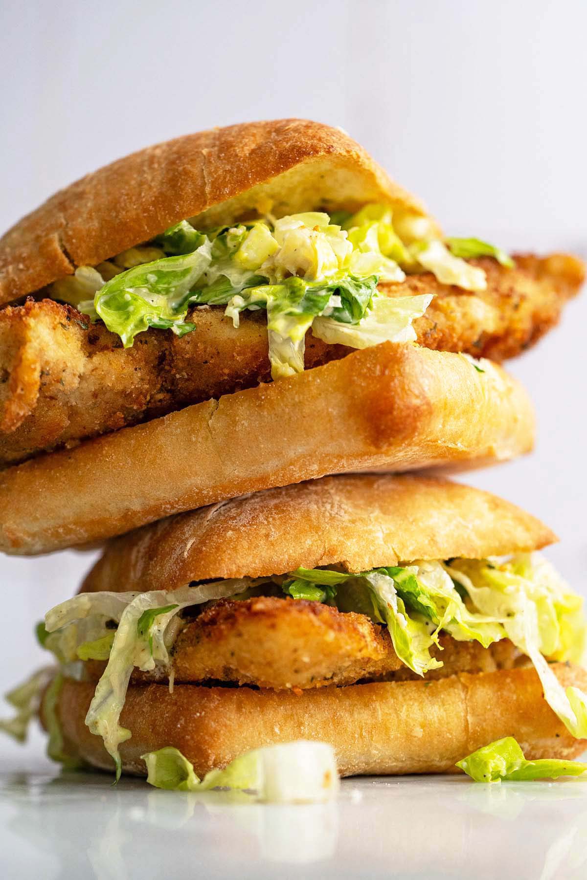 stack of chicken cutlet Caesar salad sandwiches