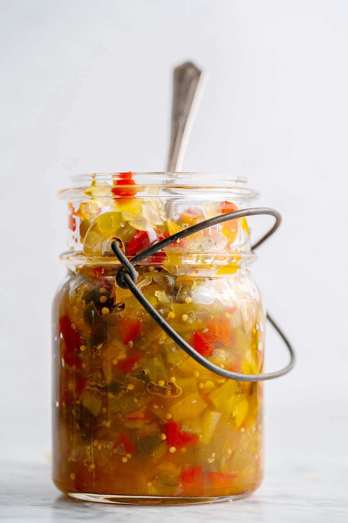 pepper relish in vintage glass jar on marble counter