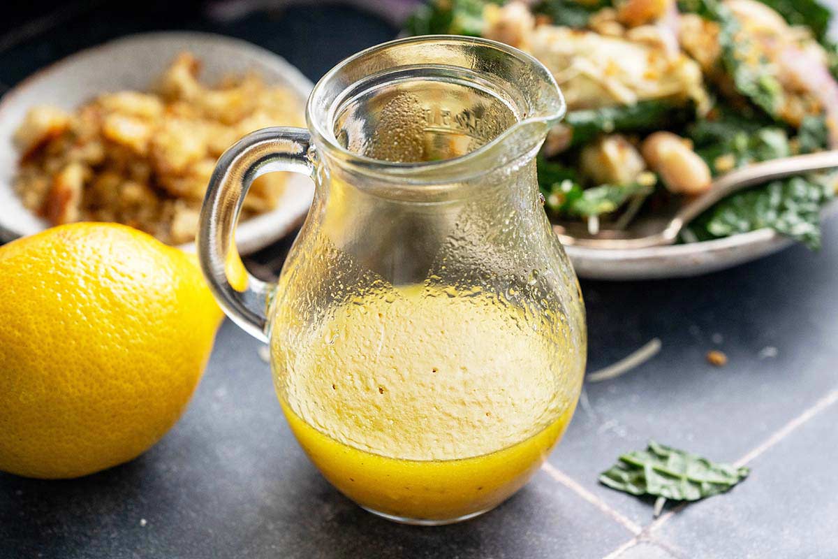 simple lemon salad dressing next to kale white bean salad