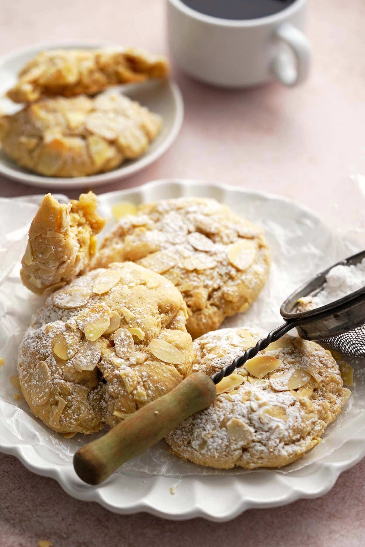 white scalloped plate with sourdough almond croissant cookies