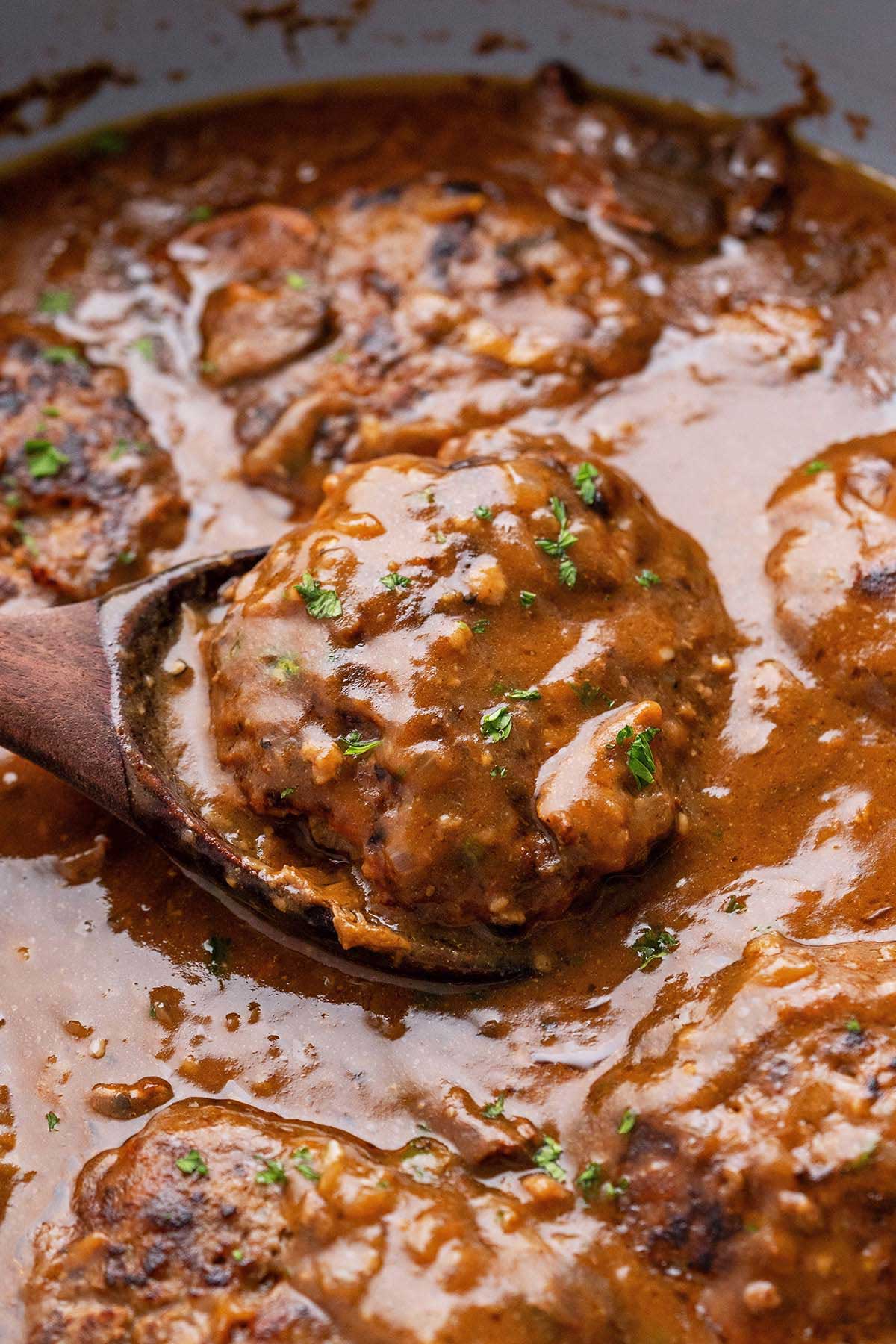 easy salisbury steak recipe with brown mushroom gravy in skillet