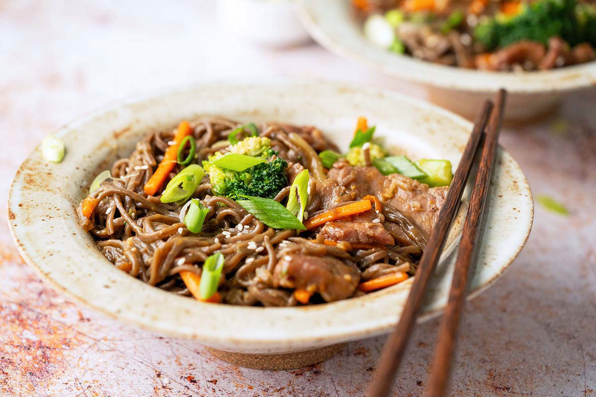 stoneware bowl with beef vegetable stir fry with soba noodles