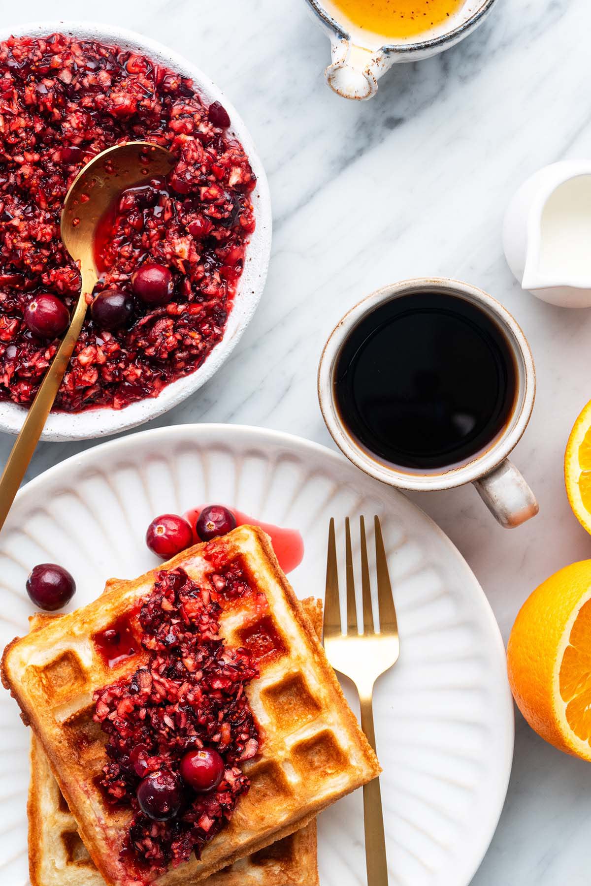 top view of Christmas brunch spread with sourdough waffles and cranberry orange relish