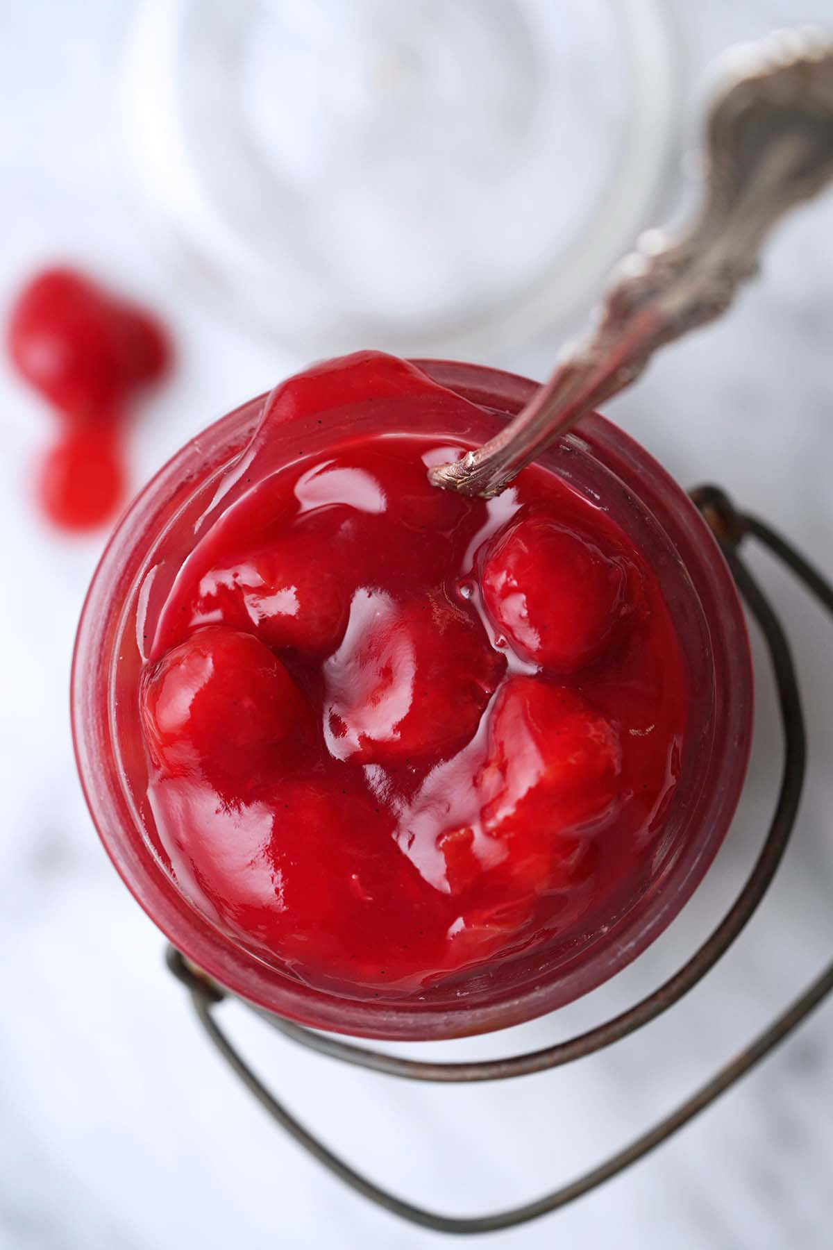 vintage glass jar containing cherry pie filling made using frozen tart cherries